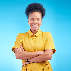 Image showing Black woman, portrait and happy in studio with a smile, confidence and a positive mindset. Fashion, arms crossed and African female model person in casual clothes on a blue background for motivation