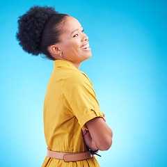 Image showing Happy, laughing and a black woman in studio with funny humor, confidence and a positive mindset. Fashion, arms crossed and profile of a female model person in casual clothes on a blue background