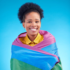 Image showing African woman, pride flag and studio portrait for smile, support or inclusion for lgbtq by blue background. Lesbian girl, rainbow fabric or happy in solidarity, protest or gay freedom for equality