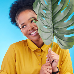 Image showing Fashion, happy and black woman with plant on blue background for cosmetics, makeup and beauty. Nature, studio and female person with monstera leaf for organic, natural and detox products for wellness