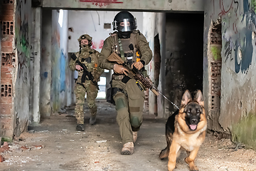 Image showing Modern Warfare Soldiers with military working dog in action on the battlefield.