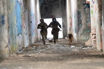 Image showing Modern Warfare Soldiers with military working dog in action on the battlefield.