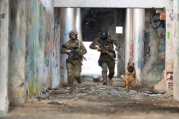 Image showing Modern Warfare Soldiers with military working dog in action on the battlefield.