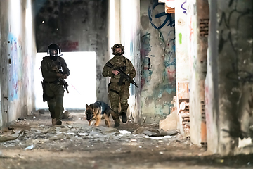 Image showing Modern Warfare Soldiers with military working dog in action on the battlefield.