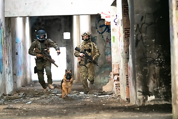 Image showing Modern Warfare Soldiers with military working dog in action on the battlefield.