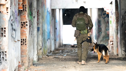 Image showing Modern Warfare Soldiers with military working dog in action on the battlefield.