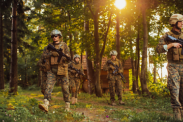 Image showing Soldier fighters standing together with guns. Group portrait of US army elite members, private military company servicemen, anti terrorist squad