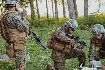 Image showing Modern Warfare Soldiers Squad are Using Drone for Scouting and Surveillance During Military Operation in the Forest.