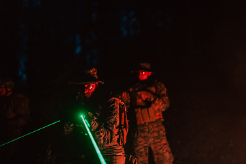 Image showing Soldiers squad in action on night mission using laser sight beam lights military team concept