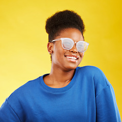 Image showing Woman, smile and studio with glasses and happy with eye care and yellow background. Face, African female person and model with eyewear, new frame and fashion with modern style and confidence of girl