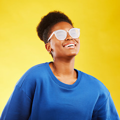 Image showing Happy, smile and glasses with face of black woman in studio for vision, eye care and confidence. Gen z, fashion and happiness with female person on yellow background for health and creative style