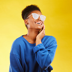 Image showing Happy, laugh and glasses with face of black woman in studio for vision, eye care and trendy style. Gen z, smile and happiness with creative female person on yellow background for pride and health