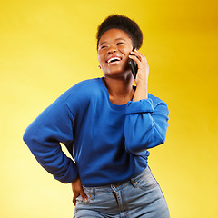 Image showing Happy, phone call and black woman in studio laugh, silly or share joke on yellow background. Funny, talking and African lady with goofy, gossip or conversation on smartphone for online communication