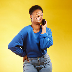 Image showing Phone call, laugh and black woman in studio happy, silly or share joke on yellow background. Funny, talking and African lady with goofy, gossip or conversation on smartphone for online communication