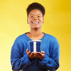 Image showing Gift, birthday and portrait of black woman with a surprise happy isolated in a yellow studio background with a present. Winning, box and excited person to celebrate, party and holiday as a winner