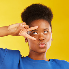 Image showing Peace, hand sign and a black woman in studio with pouting lips, confidence and a positive mindset. Emoji, icon and face of african female model person on yellow background with a v symbol and freedom