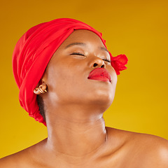 Image showing Beauty, makeup and creative with face of black woman in studio for facial, red head scarf and pride. Skincare, salon and red lipstick with model on yellow background for wellness, self care and glow