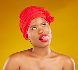 Image showing Tongue, fashion and a black woman with makeup on a studio background for beauty and comedy. Idea, playful and a funny face of African girl or model with a headscarf, cosmetics and funny on a backdrop