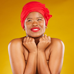 Image showing Beauty, excited and black woman with cosmetic makeup and head wrap with smile isolated in yellow studio background. Happy, skin and skincare by young female person scarf for dermatology or wellness