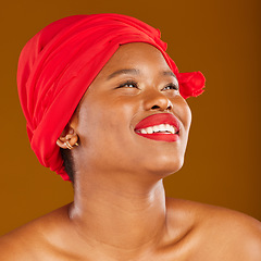 Image showing Beauty, thinking and black woman with skincare and head wrap with smile isolated in brown studio background. Happy, skin and makeup of young female person scarf for dermatology, wellness or cosmetics