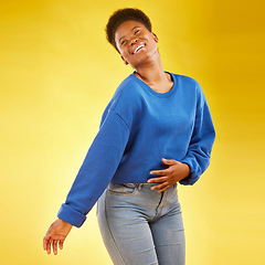 Image showing Happy, laughing and a black woman in studio with fashion, confidence and a positive mindset. Playful, funny and African female model person in casual clothes on a yellow background for motivation