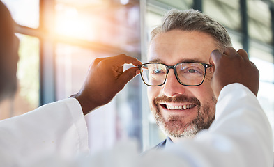 Image showing Optometry, doctor and glasses for happy man at a clinic for vision, healthcare and help with eye care. Smile, retail and a male customer with an optometrist and eyewear during a medical consultation