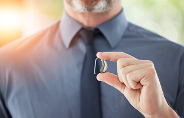 Image showing Hearing aid, hands and business man with disability for communication support, listening and medical innovation. Closeup of deaf worker with audiology implant to help sound waves, amplifier or volume