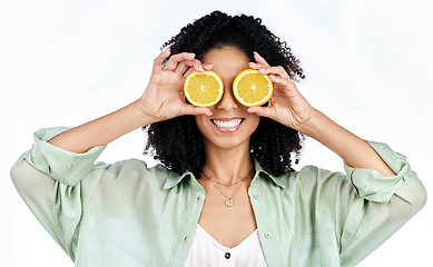 Image showing Citrus, lemon and eyes of woman with fashion for organic wellness isolated in studio white background. Diet, fruit and happy or excited young person with healthy vitamin c energy, crazy and detox