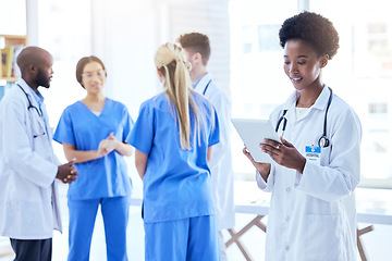 Image showing Healthcare, doctor and a black woman with a tablet at a hospital for communication and online service. Wellness, research and an African nurse or surgeon typing on technology at a clinic for medicine