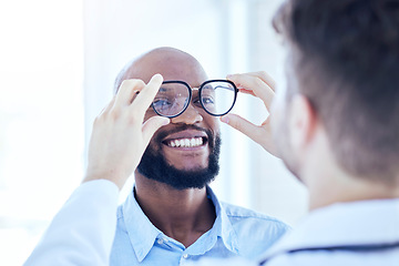 Image showing Smile, African man and optometrist with glasses for eye support and lens check at a doctor consultation. Medical, wellness and patient with vision and eyewear care with professional holding frame