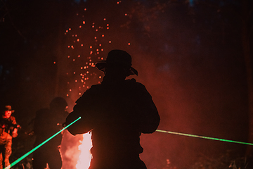 Image showing Soldiers squad in action on night mission using laser sight beam lights military team concept