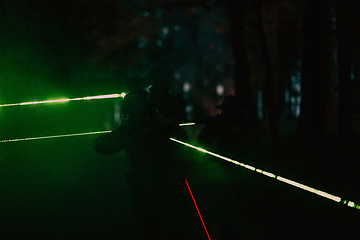 Image showing Soldiers squad in action on night mission using laser sight beam lights military team concept