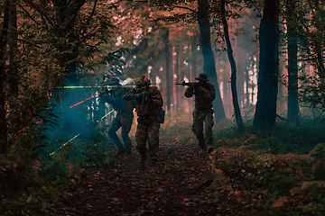 Image showing Soldiers squad in action on night mission using laser sight beam lights military team concept