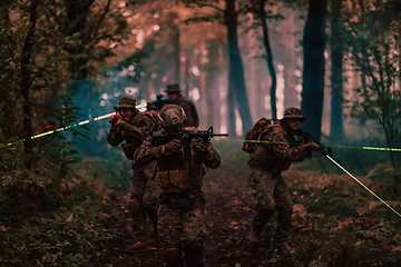 Image showing Soldiers squad in action on night mission using laser sight beam lights military team concept