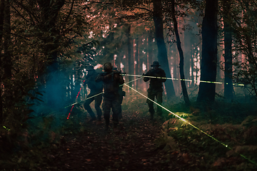 Image showing Soldiers squad in action on night mission using laser sight beam lights military team concept