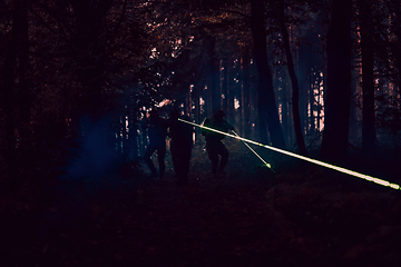 Image showing Soldiers squad in action on night mission using laser sight beam lights military team concept