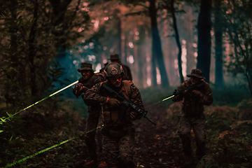 Image showing Soldiers squad in action on night mission using laser sight beam lights military team concept