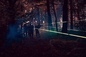 Image showing Soldiers squad in action on night mission using laser sight beam lights military team concept