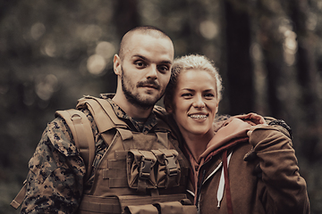 Image showing Happy woman in love hugging hero soldier