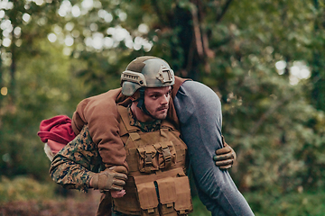 Image showing Soldier rescue civilian woman in battle and give medical support help and assistance