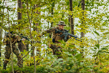 Image showing A modern warfare soldier on war duty in dense and dangerous forest areas. Dangerous military rescue operations