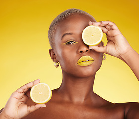 Image showing Black woman, portrait and lemon for vitamin C or natural beauty against a yellow studio background. African female person with organic citrus fruit for diet, detox or facial cosmetics and makeup