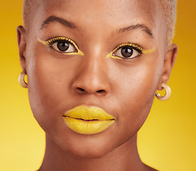 Image showing Creative, portrait and cosmetics with african girl with glow in closeup with yellow studio background. Serious, face and makeup with art for beauty or luxury lipstick with design for aesthetic.