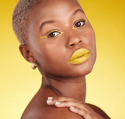 Image showing Portrait, skincare and cosmetics with african girl for glow in yellow studio or background in closeup. Woman, serious and beauty face with creative art or makeup for luxury treatment with eyeliner.