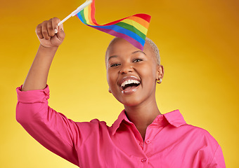 Image showing Flag, pride and portrait of black woman with support of the lgbtq community isolated in a studio yellow background. Smile, happy and gen z or young gay person with rainbow symbol of equality