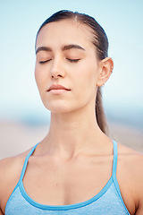 Image showing Calm, fitness and woman at beach for meditation, training the mind and exercise for zen. Yoga, nature and face of a young girl with peace during a wellness and spiritual workout at the sea to relax