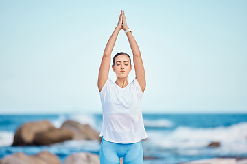 Image showing Yoga, fitness and woman at the beach for workout or training as health, mindfulness and wellness routine. Healthy, body and person exercise a chakra by doing tree pose at the sea or in nature