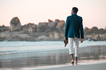 Image showing Walking, beach and back of business man for journey on holiday, vacation and freedom by ocean. Professional, travel and male entrepreneur barefoot for calm, peace and relaxing in nature at sunset