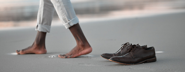 Image showing Shoes, walk and beach for business man, freedom and sunset to relax in nature by water after work. Person, ground and ocean with barefoot adventure for vacation, outdoor and steps on sand at dusk