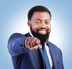 Image showing Portrait, business and black man hand pointing in studio for hiring, recruitment or opportunity on blue background. Face, smile and African male person with you, emoji and coming soon or contact us